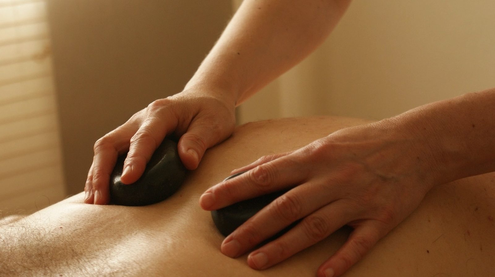 Hands performing a massage treatment